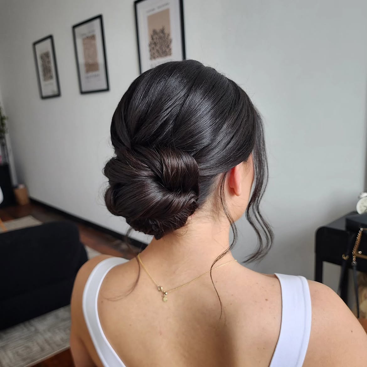 Polished Low Chignon With Face Framing Tendrils