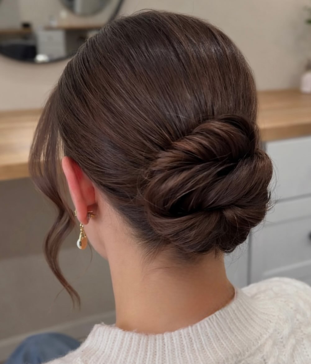 Polished Low Chignon With Face Framing Tendrils