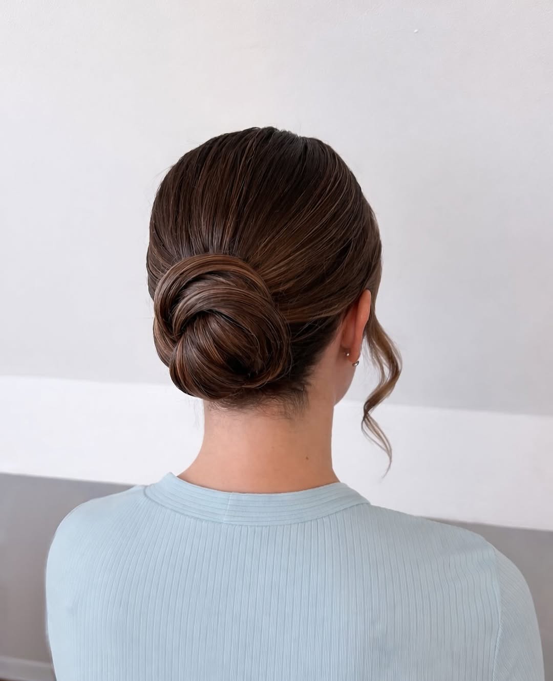 Polished Low Chignon With Face Framing Tendrils