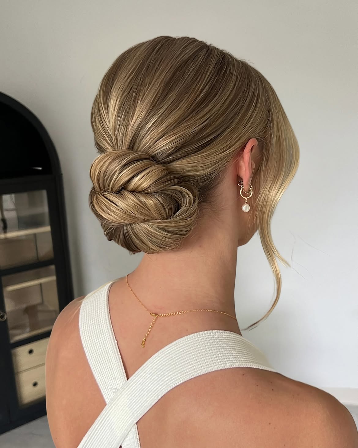 Polished Low Chignon With Face Framing Tendrils