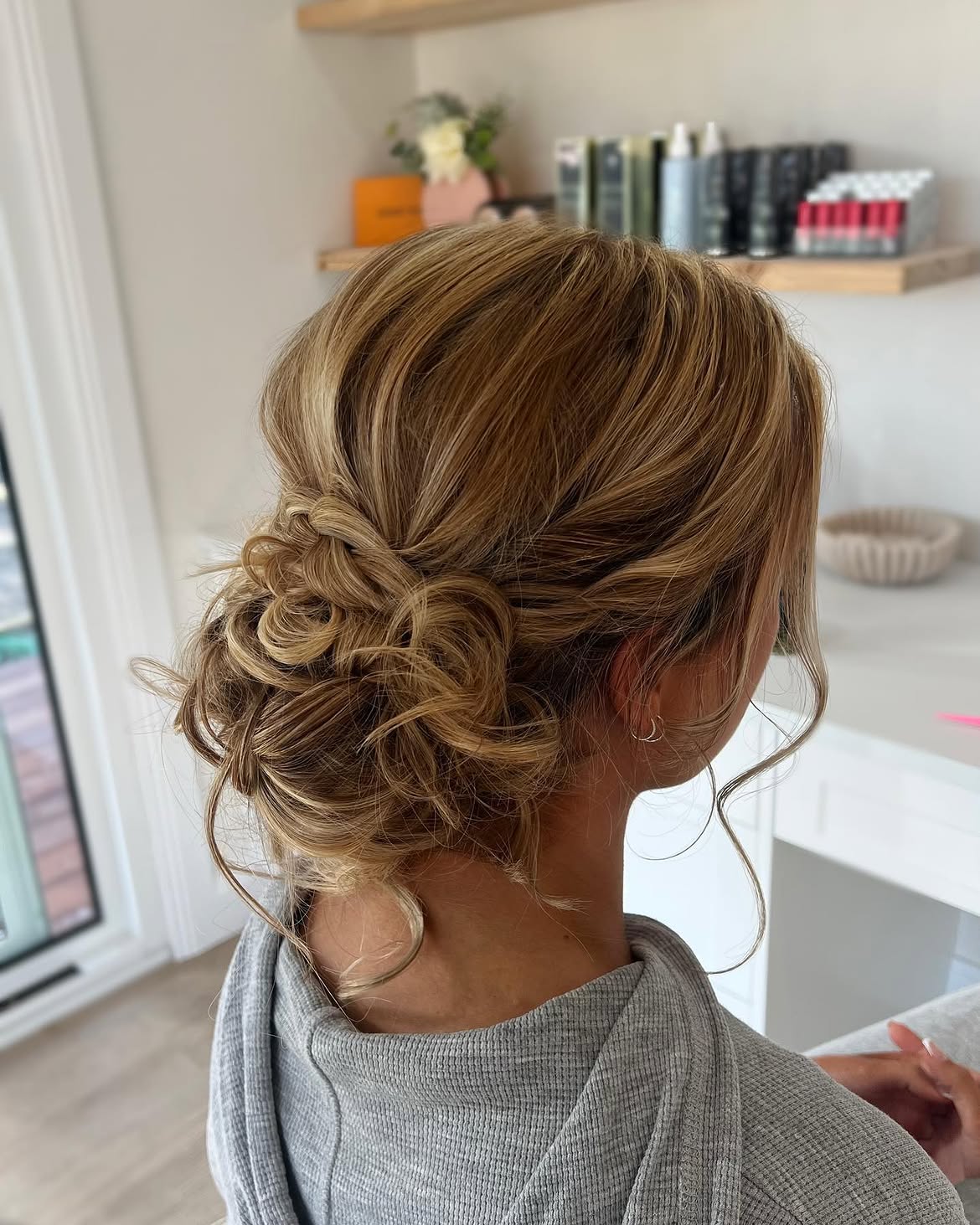 Romantic Tousled Low Updo With Loose Tendrils