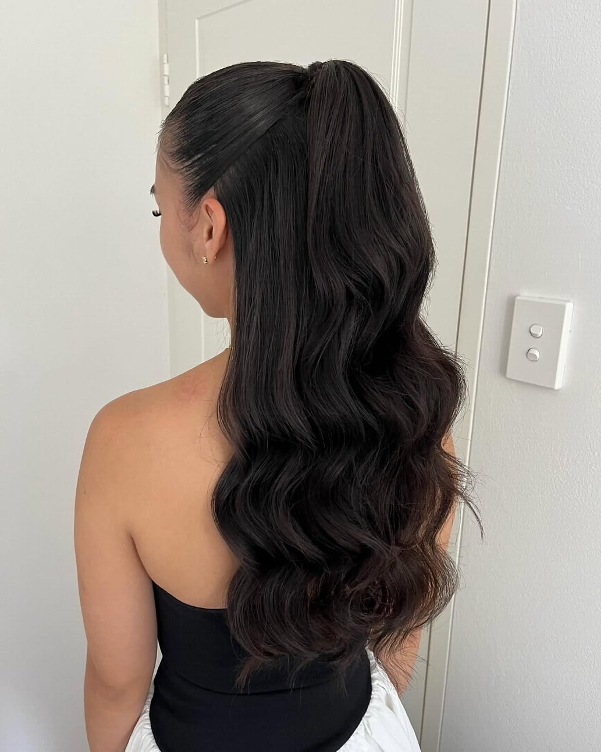 Sleek High Half Ponytail With Voluminous Waves