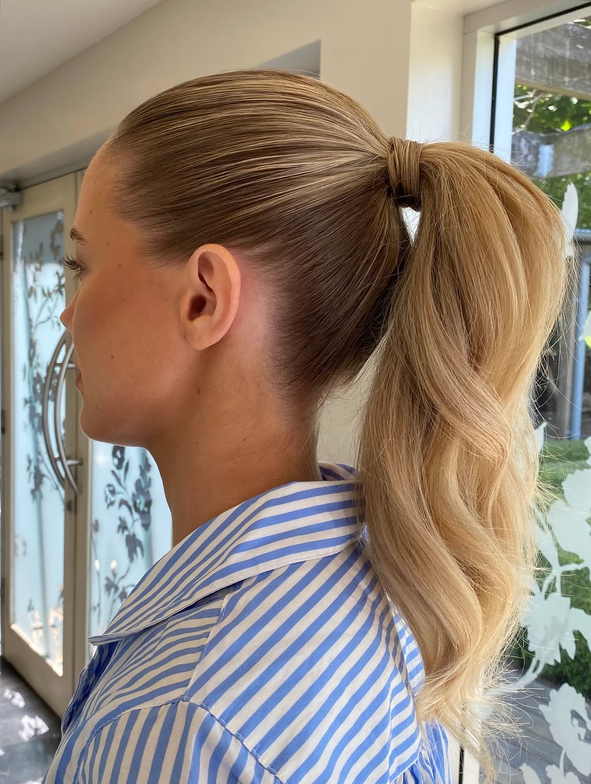 Sleek High Ponytail With Loose Barrel Curls