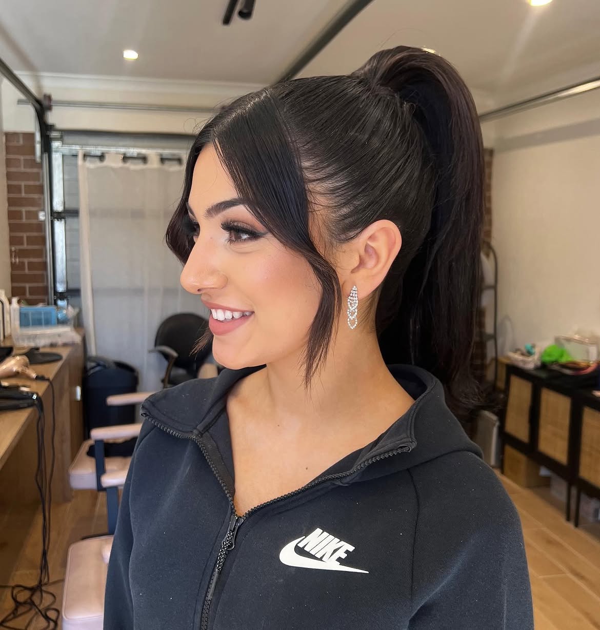 Sleek High Ponytail With Wispy Face-Framing Pieces