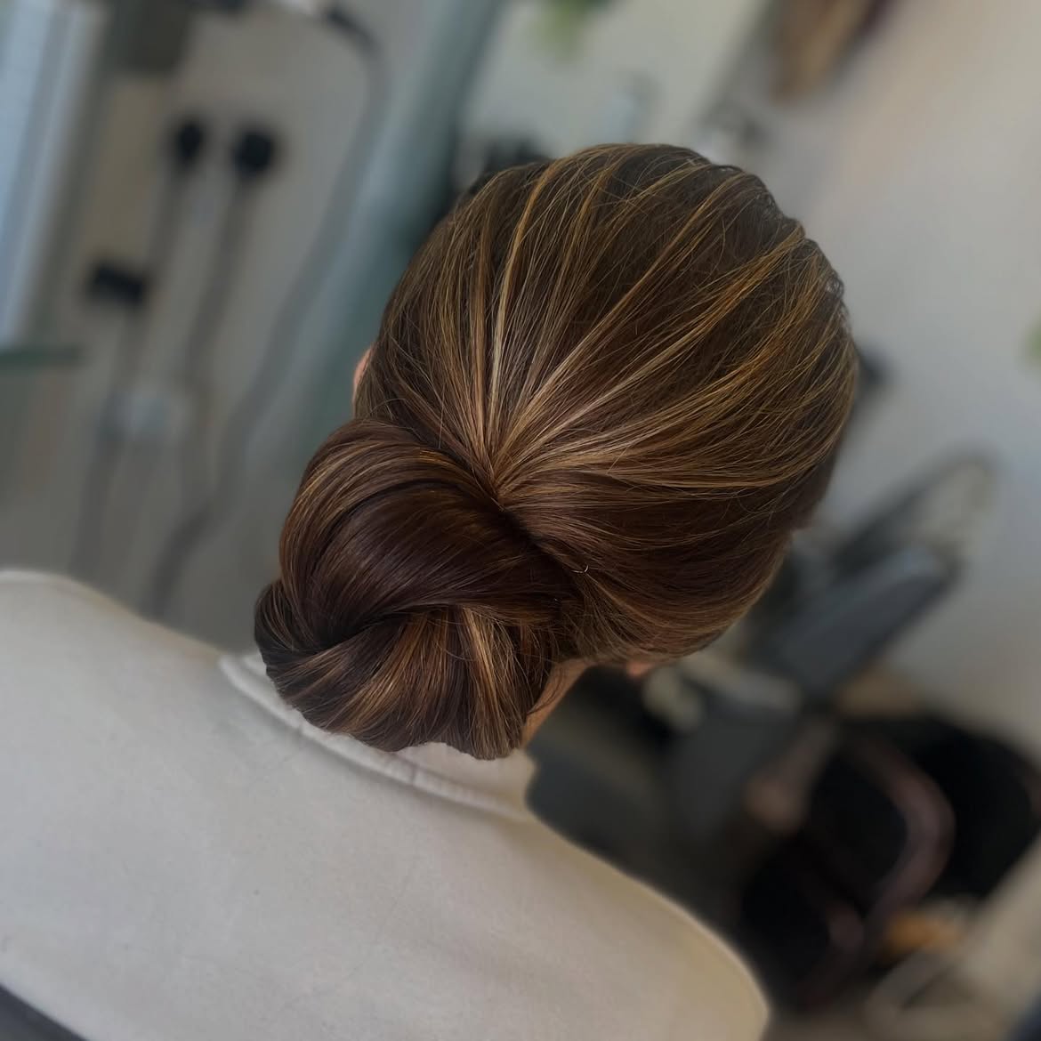 Sleek Low Bun With Dimensional Caramel Highlights