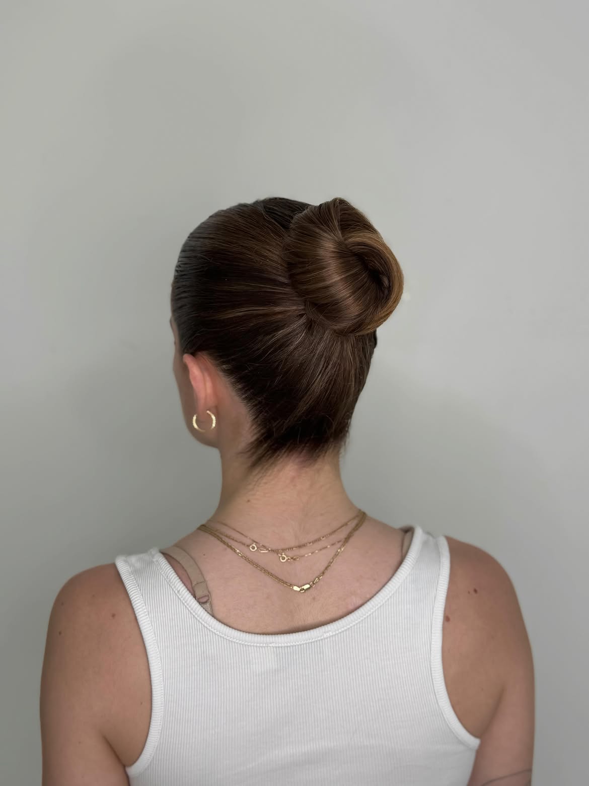 Sleek Low Chignon With Natural Brown Gloss