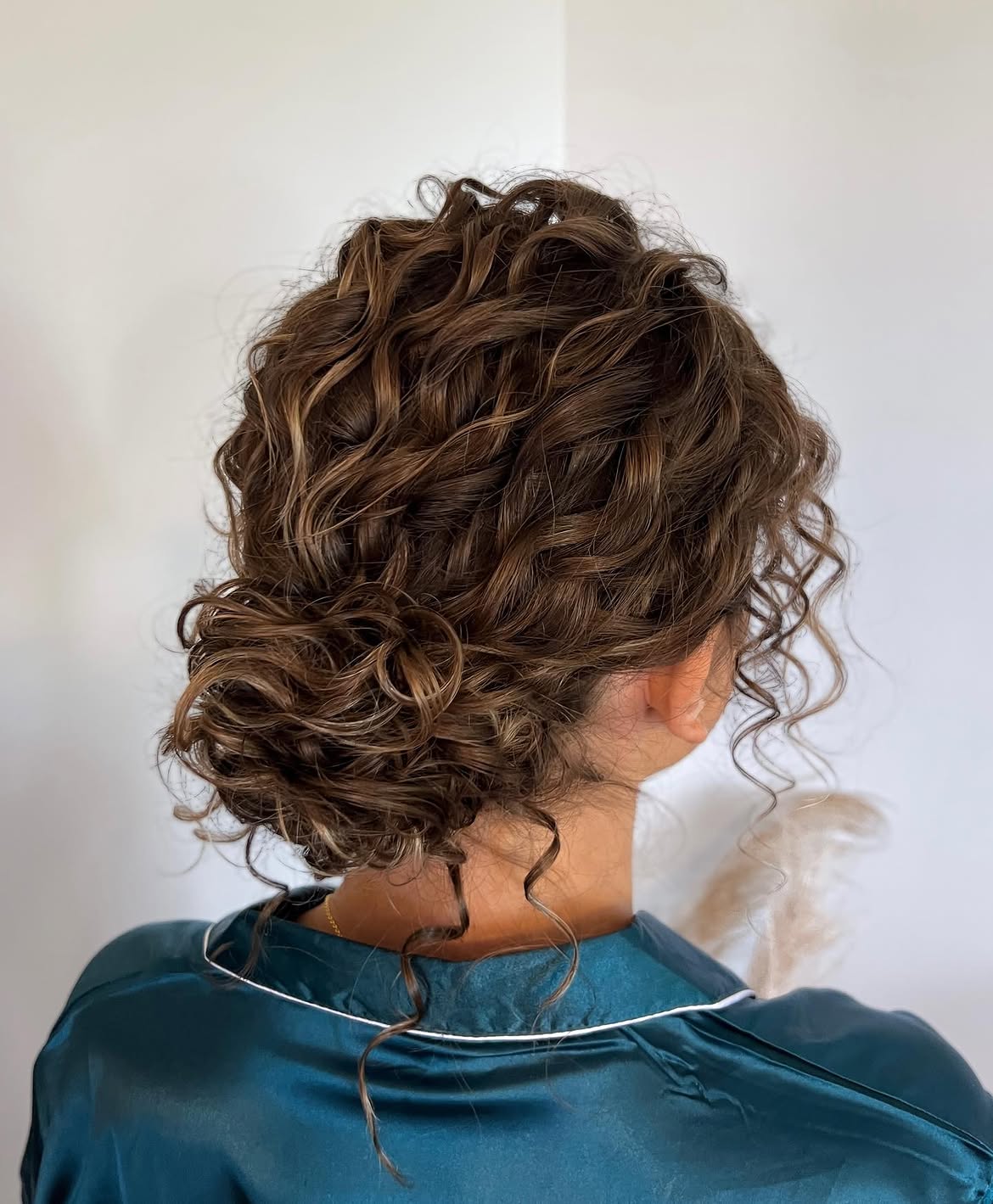 Soft Romantic Low Messy Bun For Curly Hair