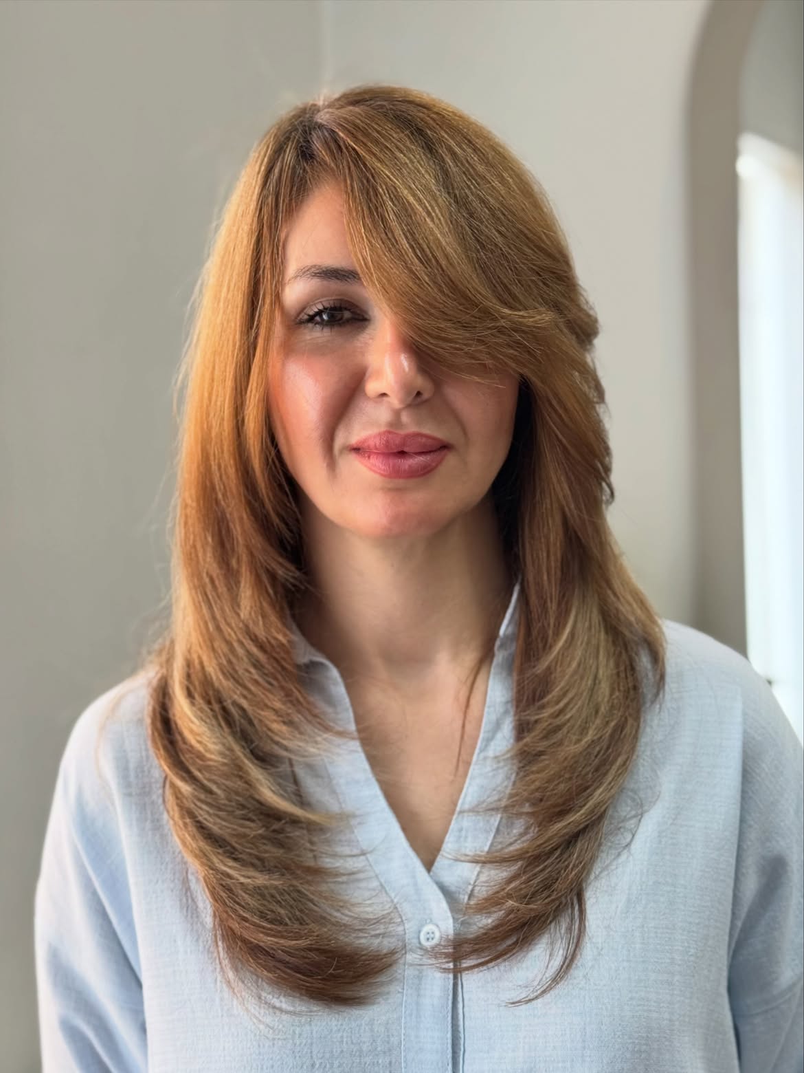 Soft Side Swept Bangs On Layered Copper Hair