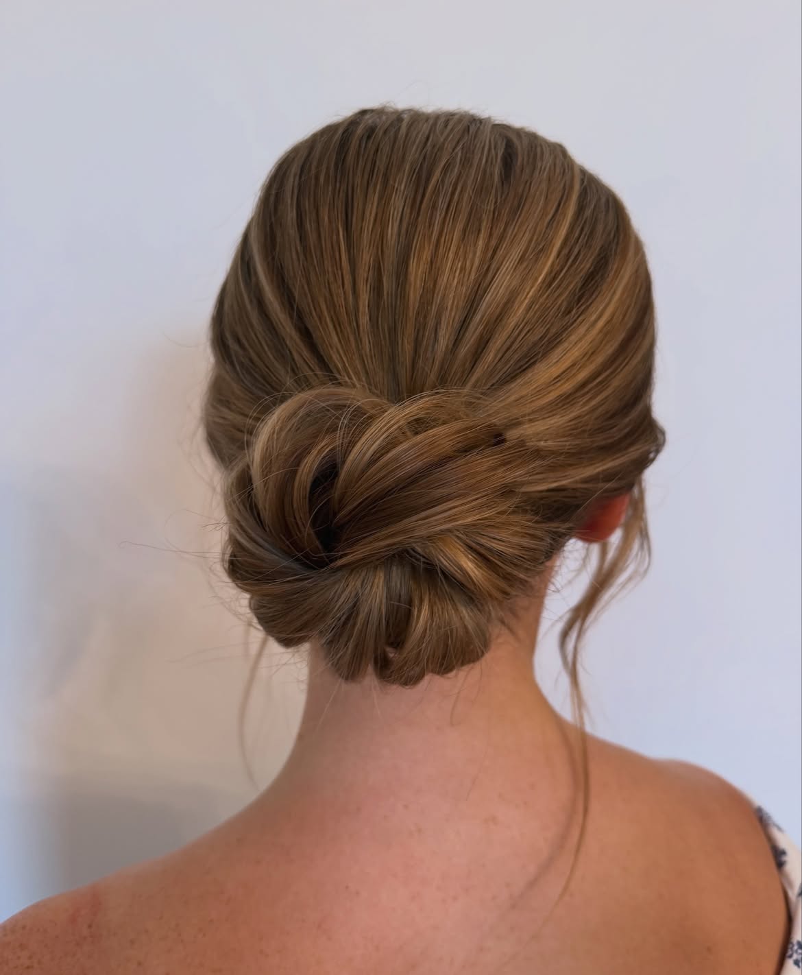 Soft Tousled Low Bun With Face Framing Tendrils