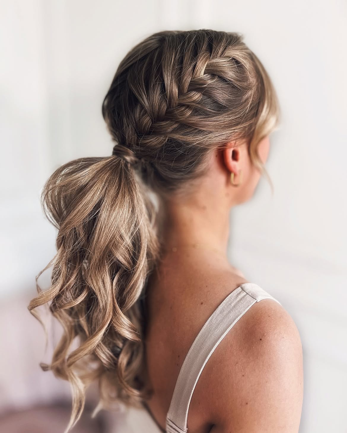Textured French Braid High Ponytail With Loose Curls
