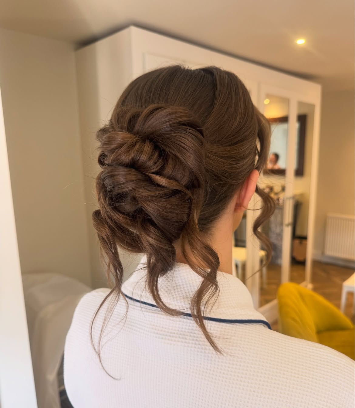 Textured Low Bun With Soft Face Framing Tendrils