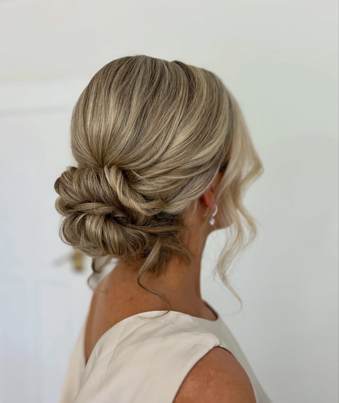 Textured Low Chignon With Face Framing Tendrils