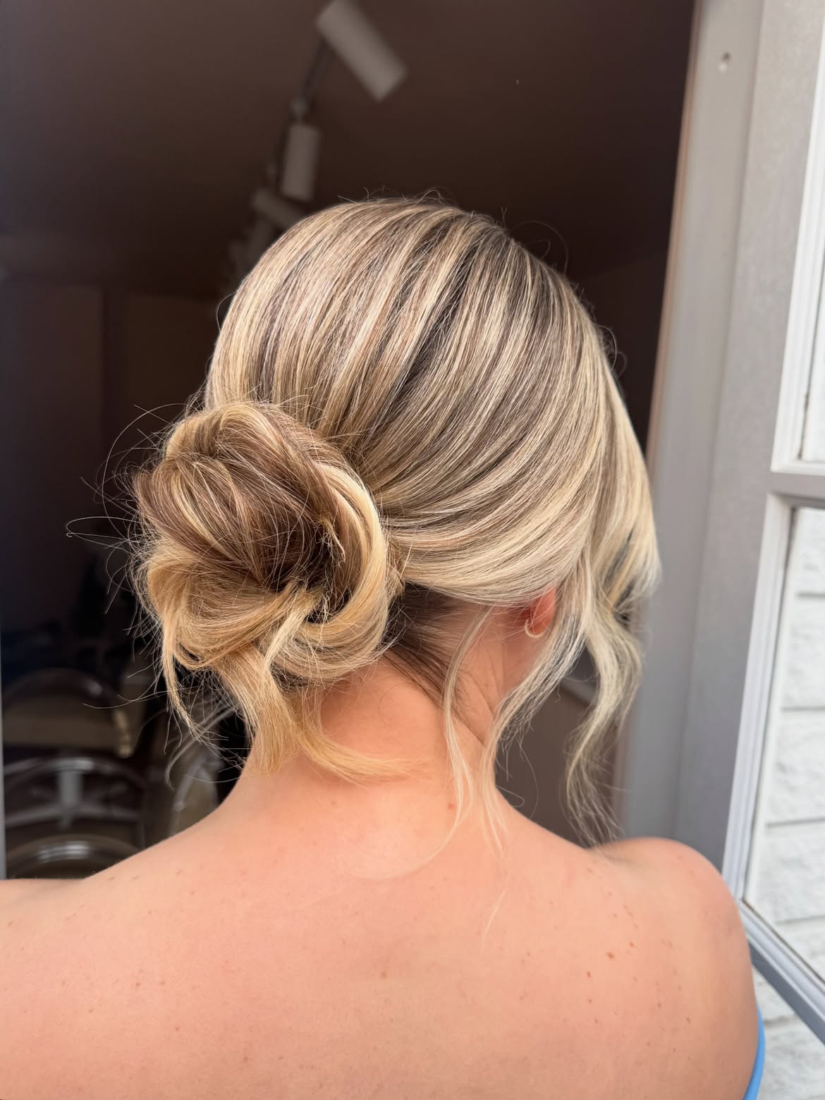 Textured Low Messy Bun With Blonde Highlights