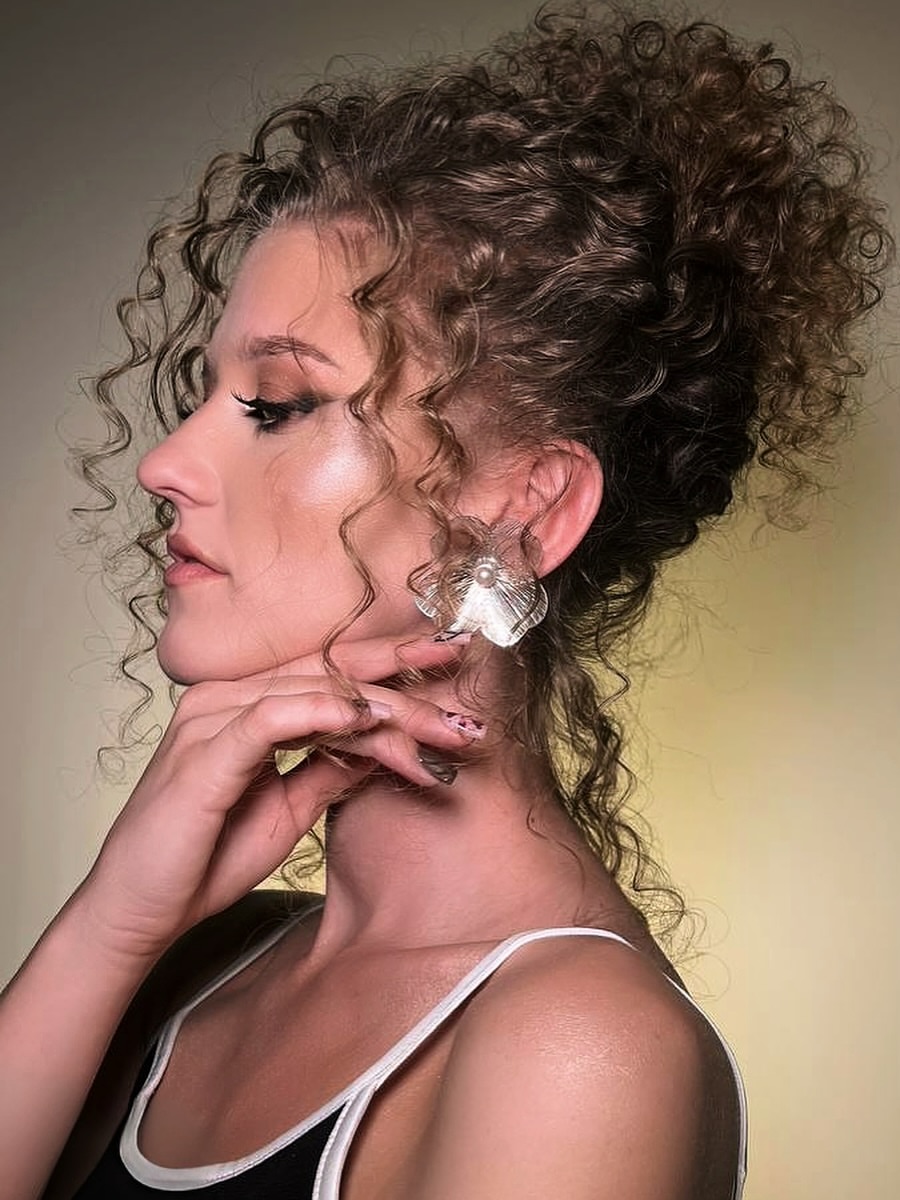 Tousled High Bun With Defined Spiral Curls