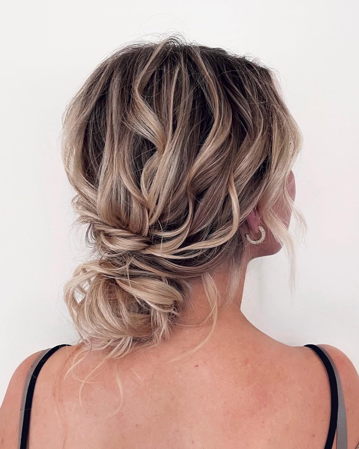 Tousled Low Bun With Face-Framing Strands
