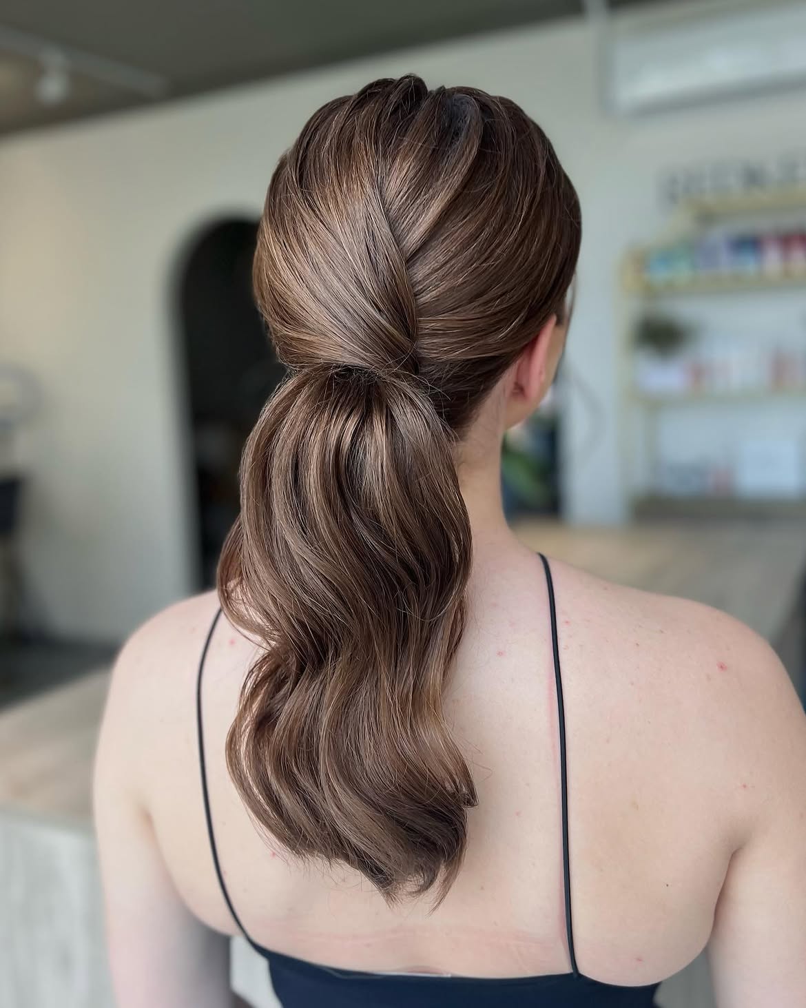 Twisted Low Ponytail With Soft Barrel Curls