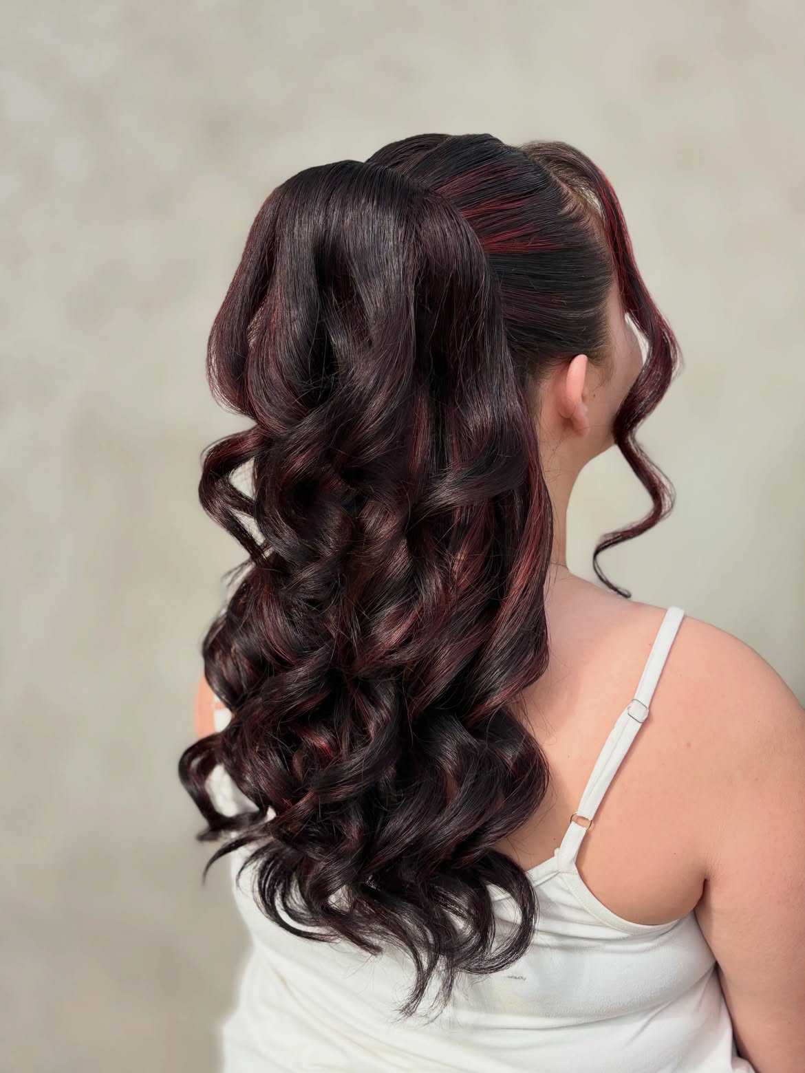 Voluminous Curly High Ponytail With Burgundy Highlights