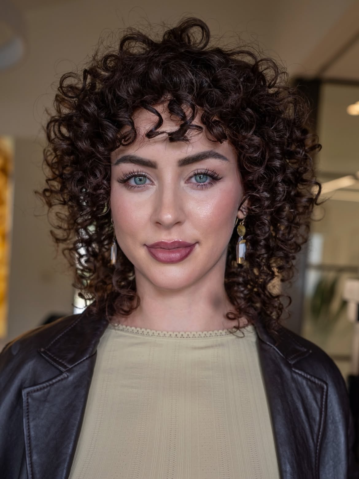 Voluminous Defined Curls With Face Framing Bangs