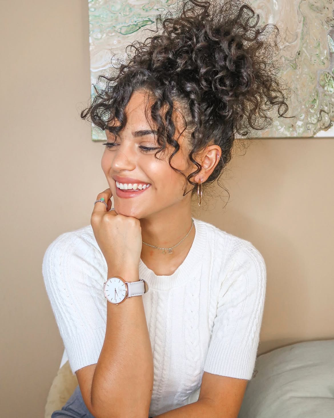 Voluminous High Curly Bun With Face-Framing Tendrils