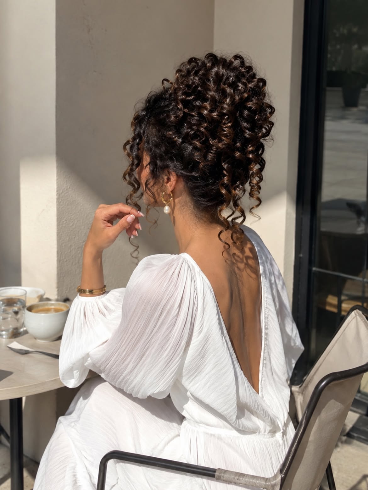Voluminous High Curly Bun With Natural Texture