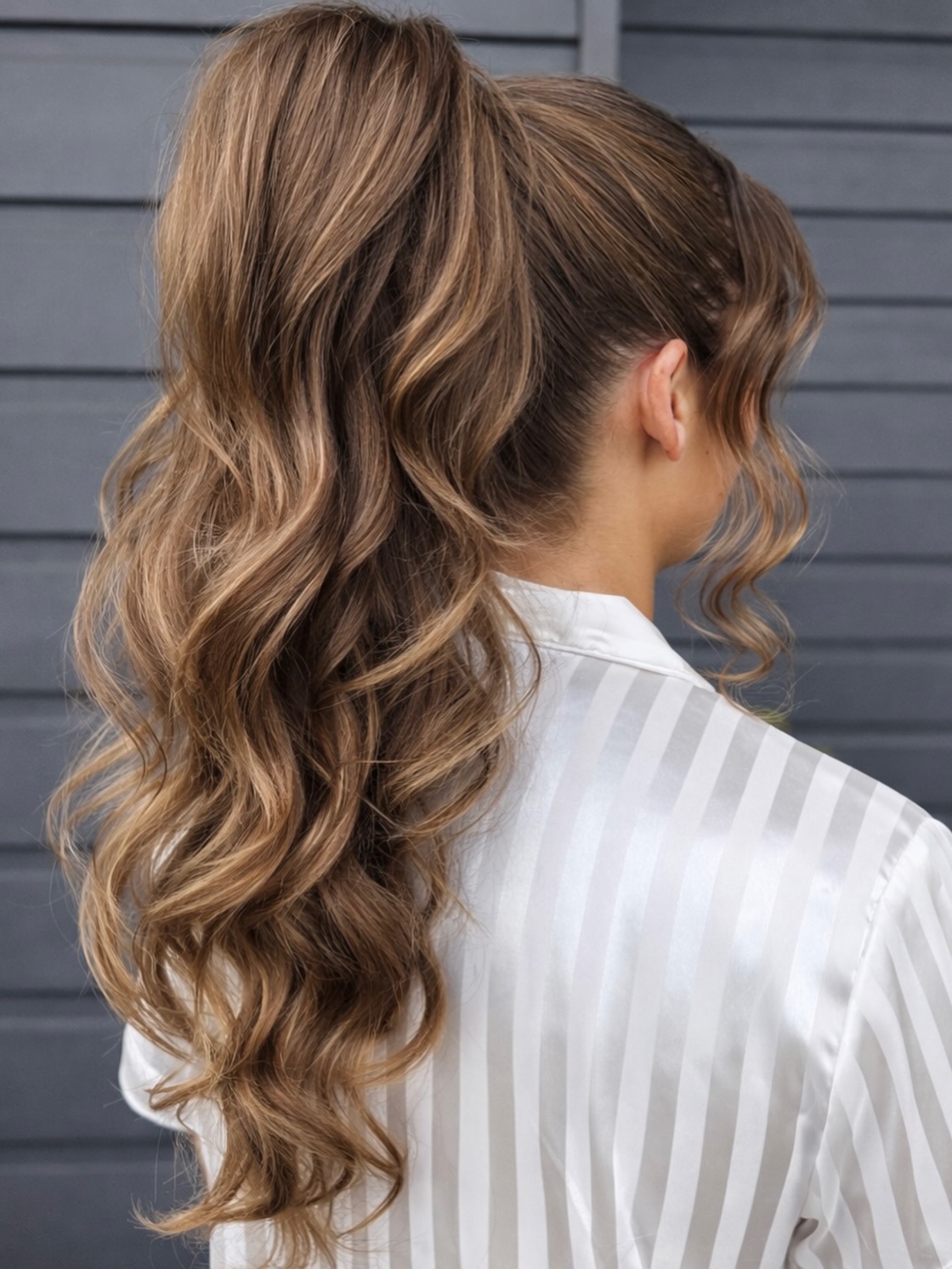 Voluminous Wavy High Ponytail With Face Framing Pieces