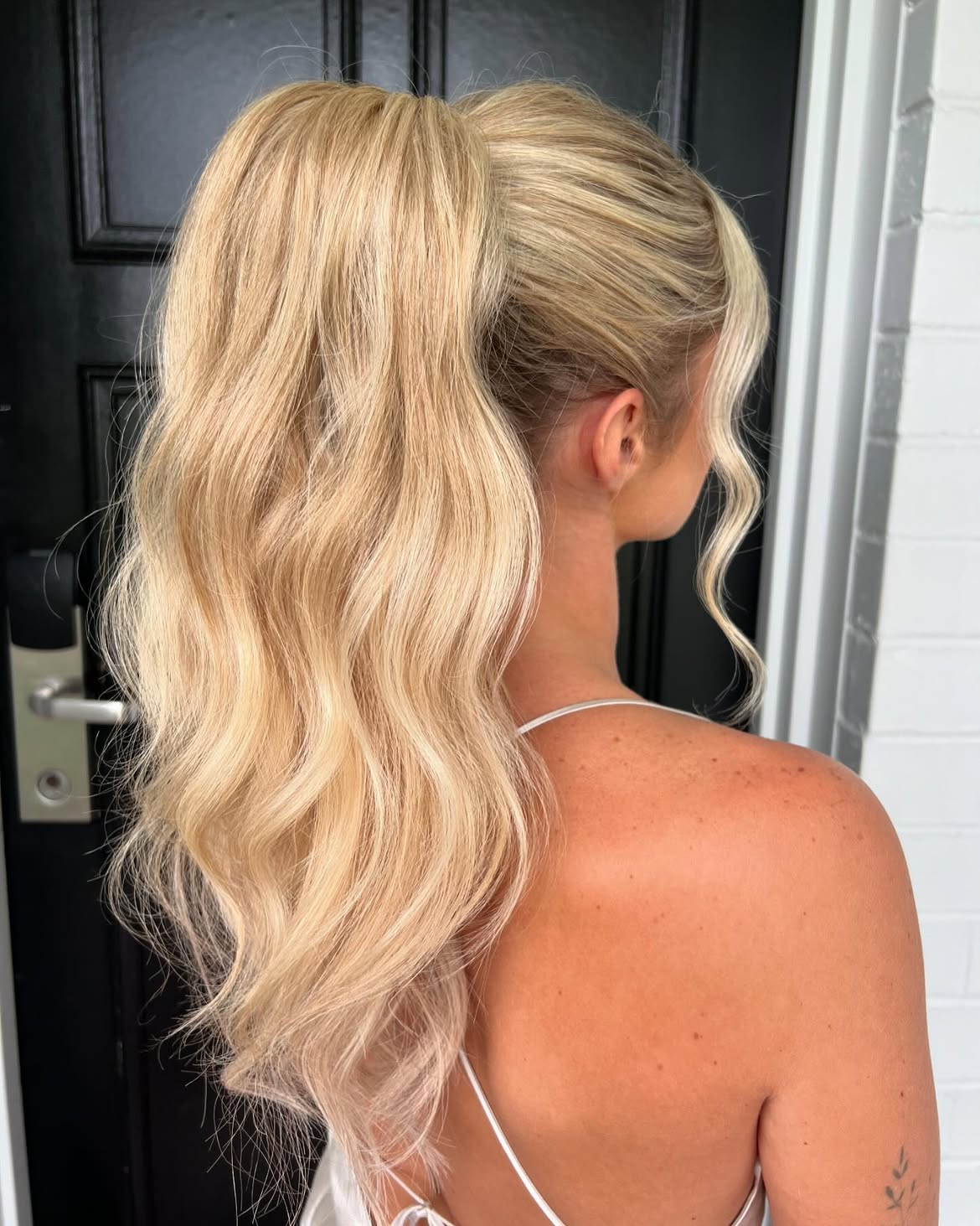 Voluminous Wavy High Ponytail With Face Framing Pieces