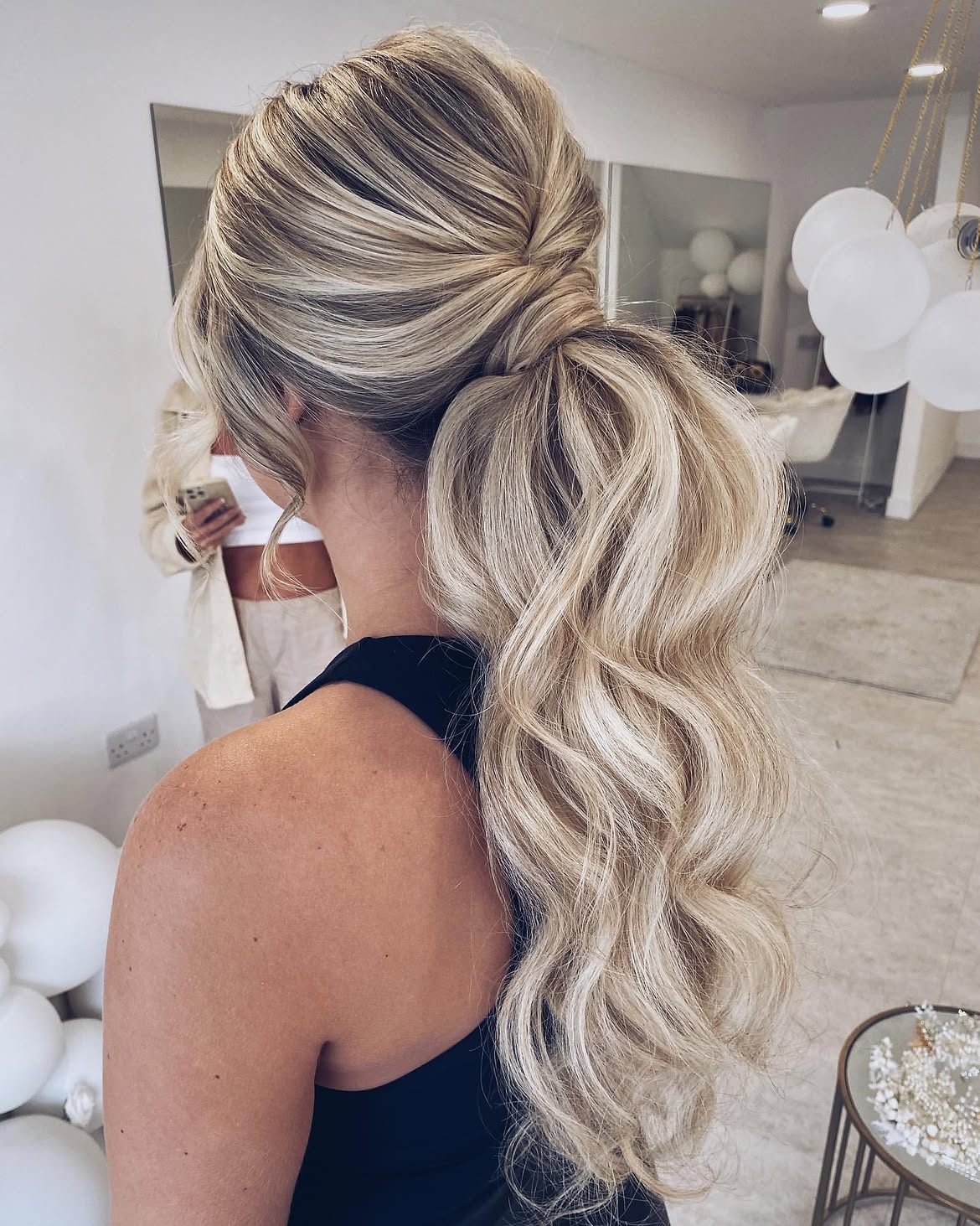 Voluminous Wavy Ponytail With Blonde Highlights