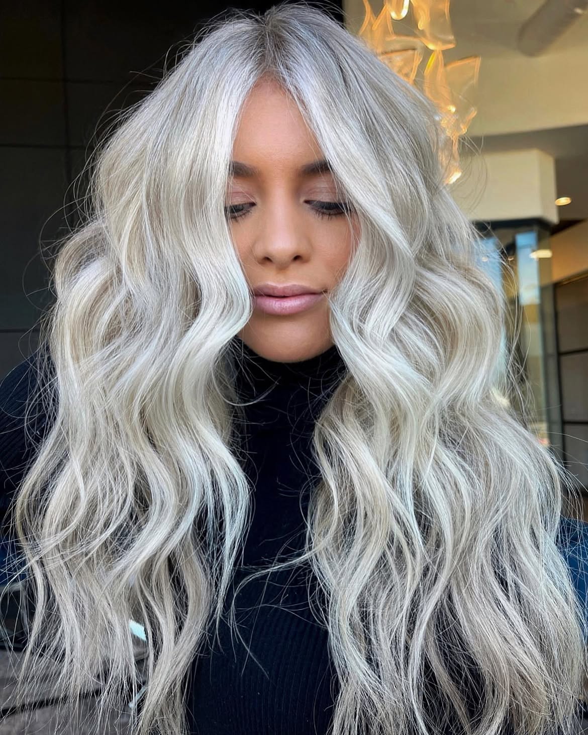 Bright Platinum Blonde Waves With Face Framing Layers