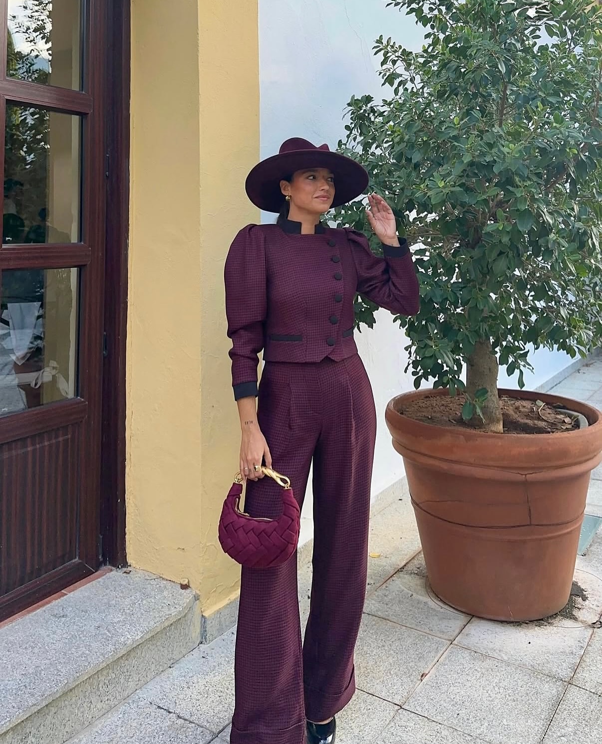 Burgundy Tailored Suit With Statement Hat