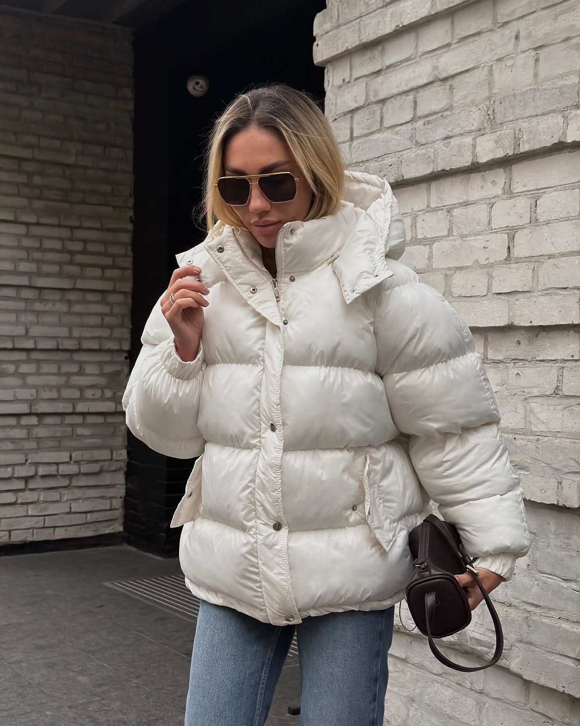 Chic White Puffer With Blue Denim And Brown Bag