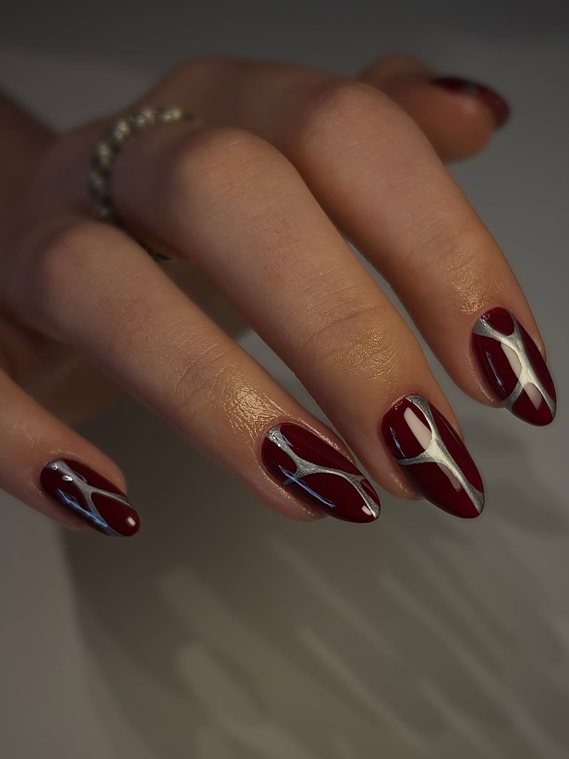 Deep Burgundy Almond Nails with Silver Abstract Art