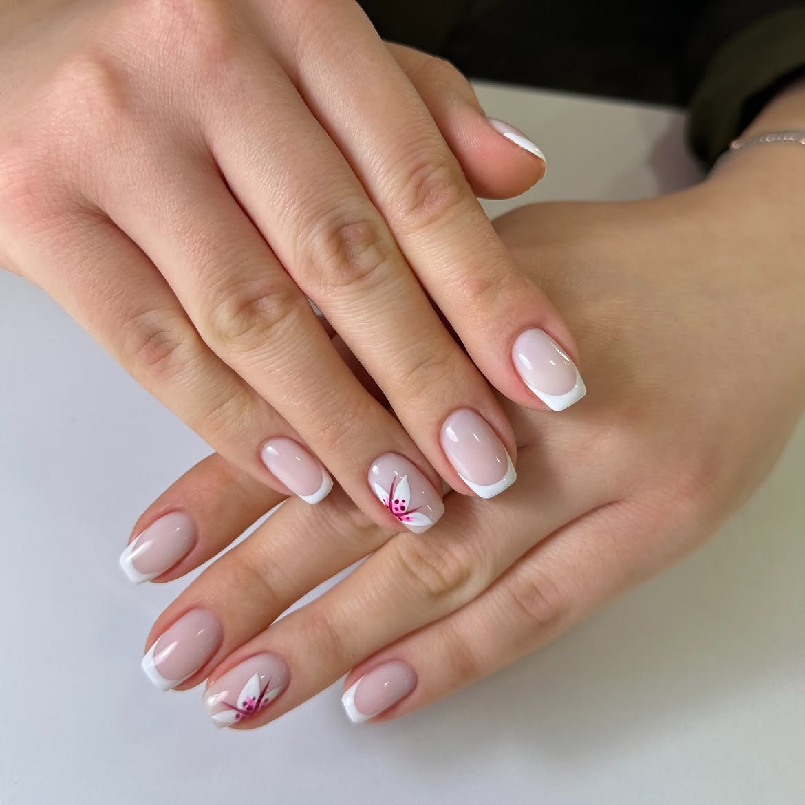 Delicate French Tips with Floral Accent