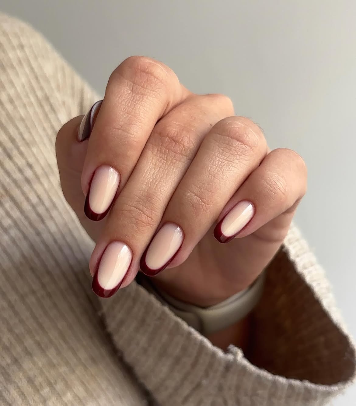 Glossy Burgundy French Tips On Almond Nails
