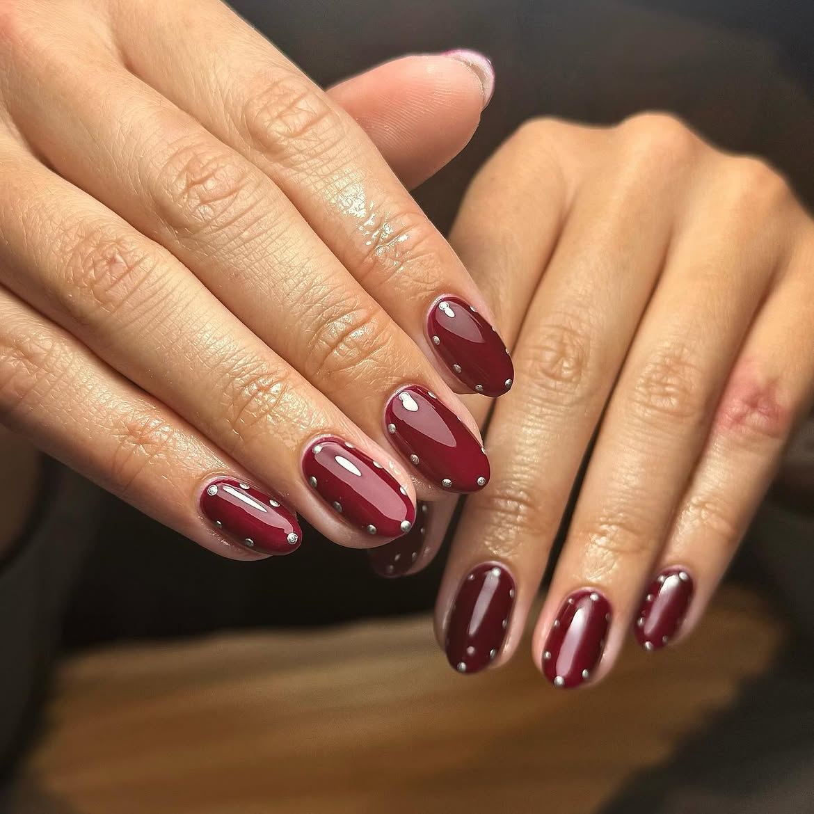 Glossy Burgundy Oval Nails with Silver Studs