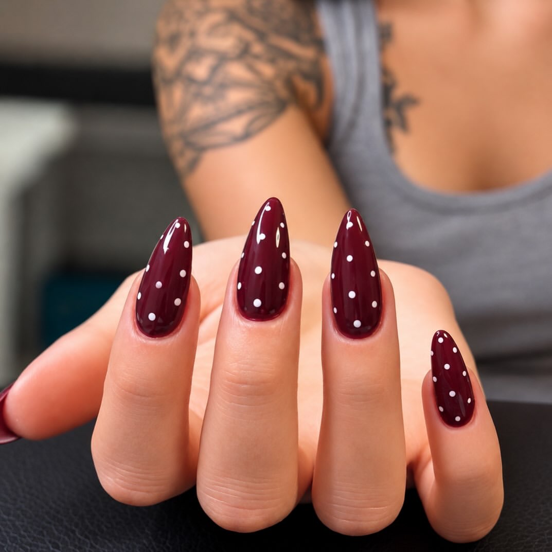 Glossy Burgundy Stiletto Nails With White Polka Dots