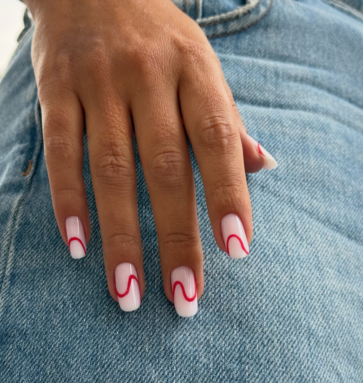 Glossy Milky White Nails With Red Swirl Art