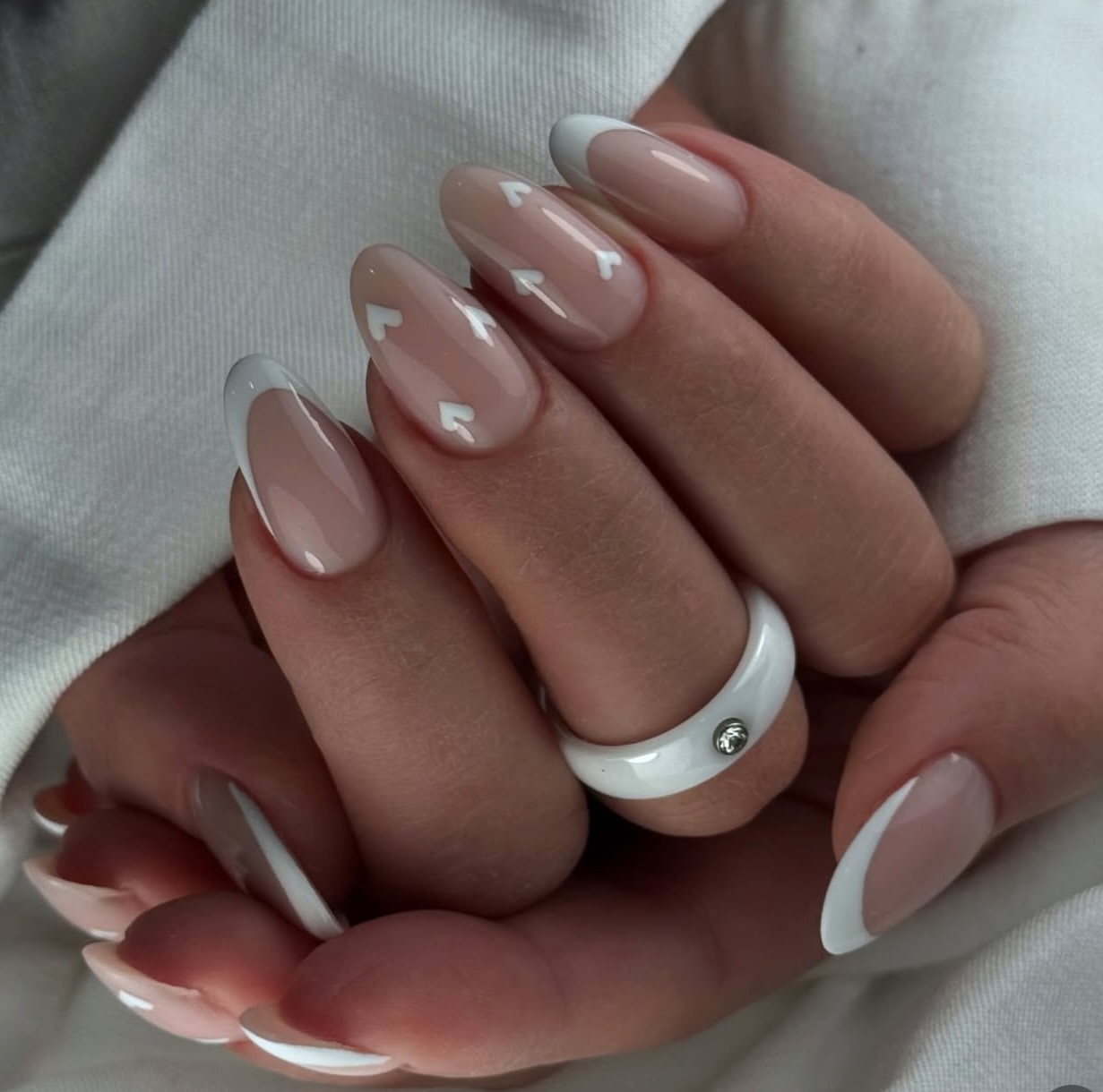 Glossy Nude Almond French Tips with White Hearts