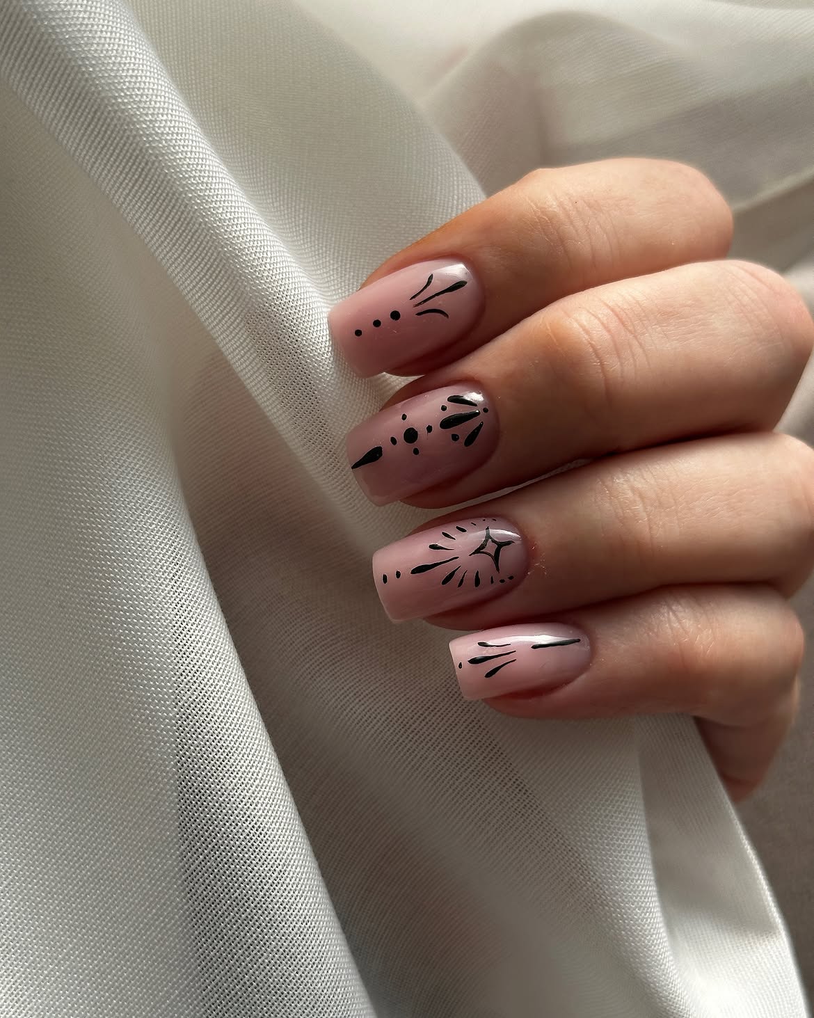 Glossy Nude Pink Coffin Nails with Black Starburst Art