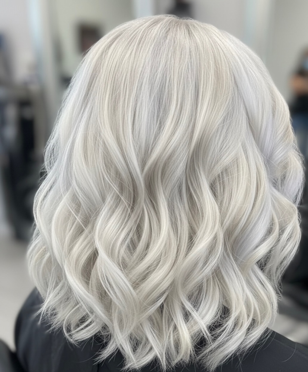 Icy Platinum Blonde Waves On Shoulder Length Lob