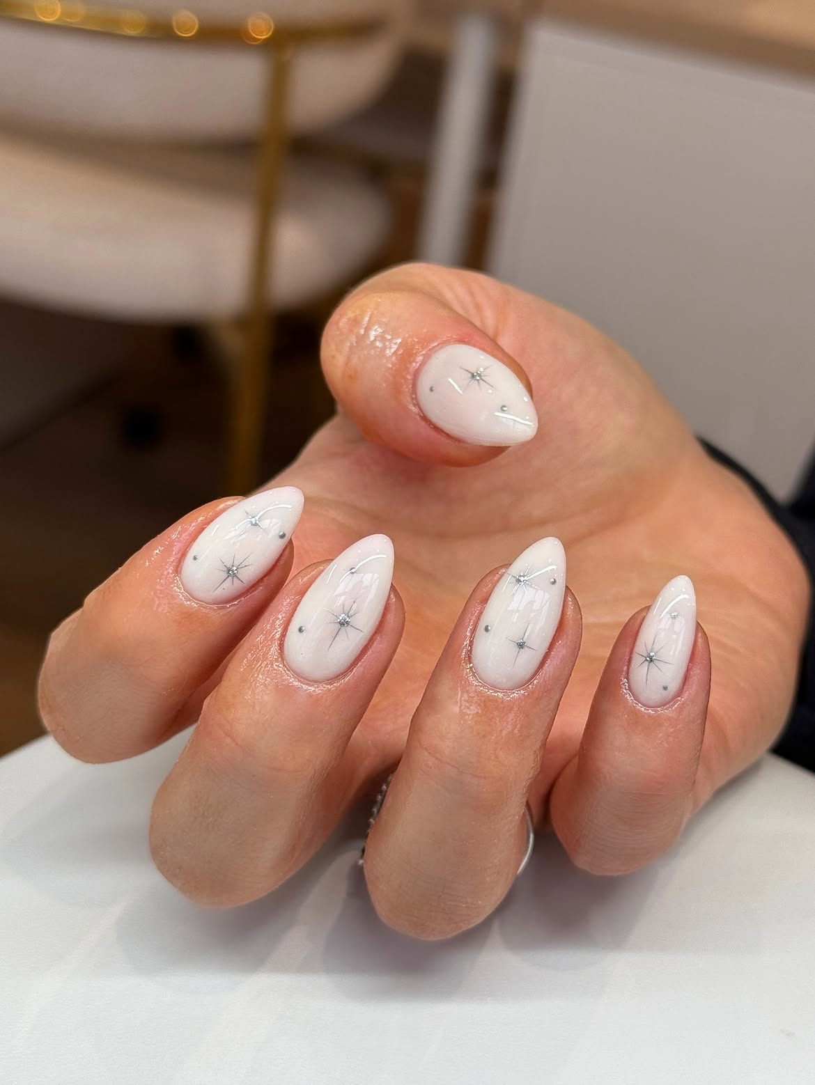 Milky White Almond Nails with Silver Star Accents