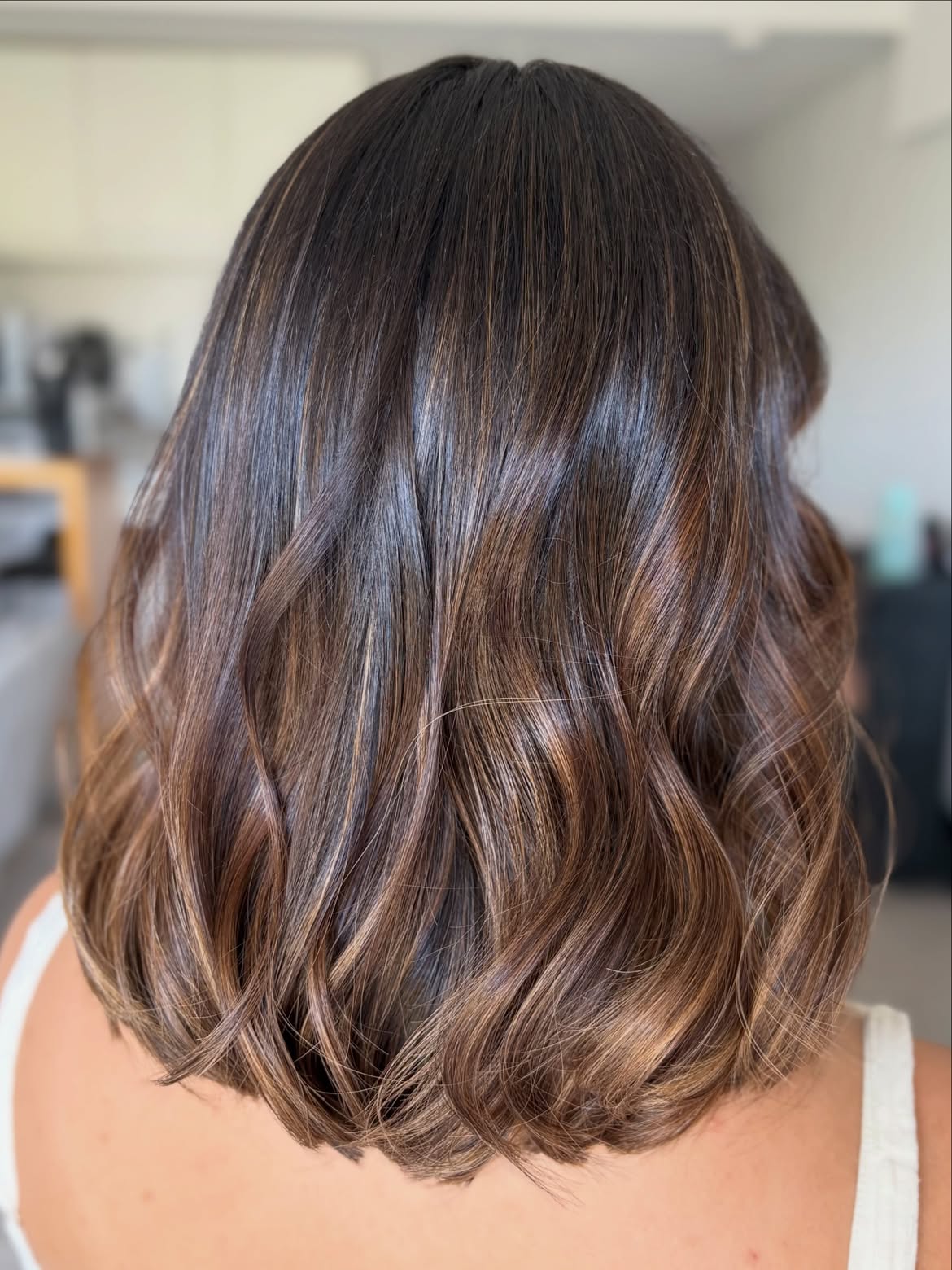 Rich Brunette Balayage On Textured Shoulder Length Cut