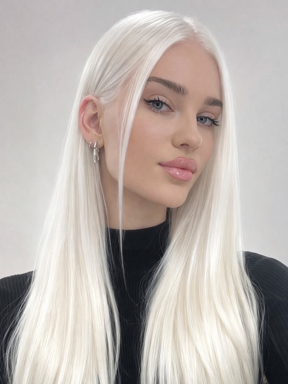 Sleek Platinum Blonde With Face Framing Layers