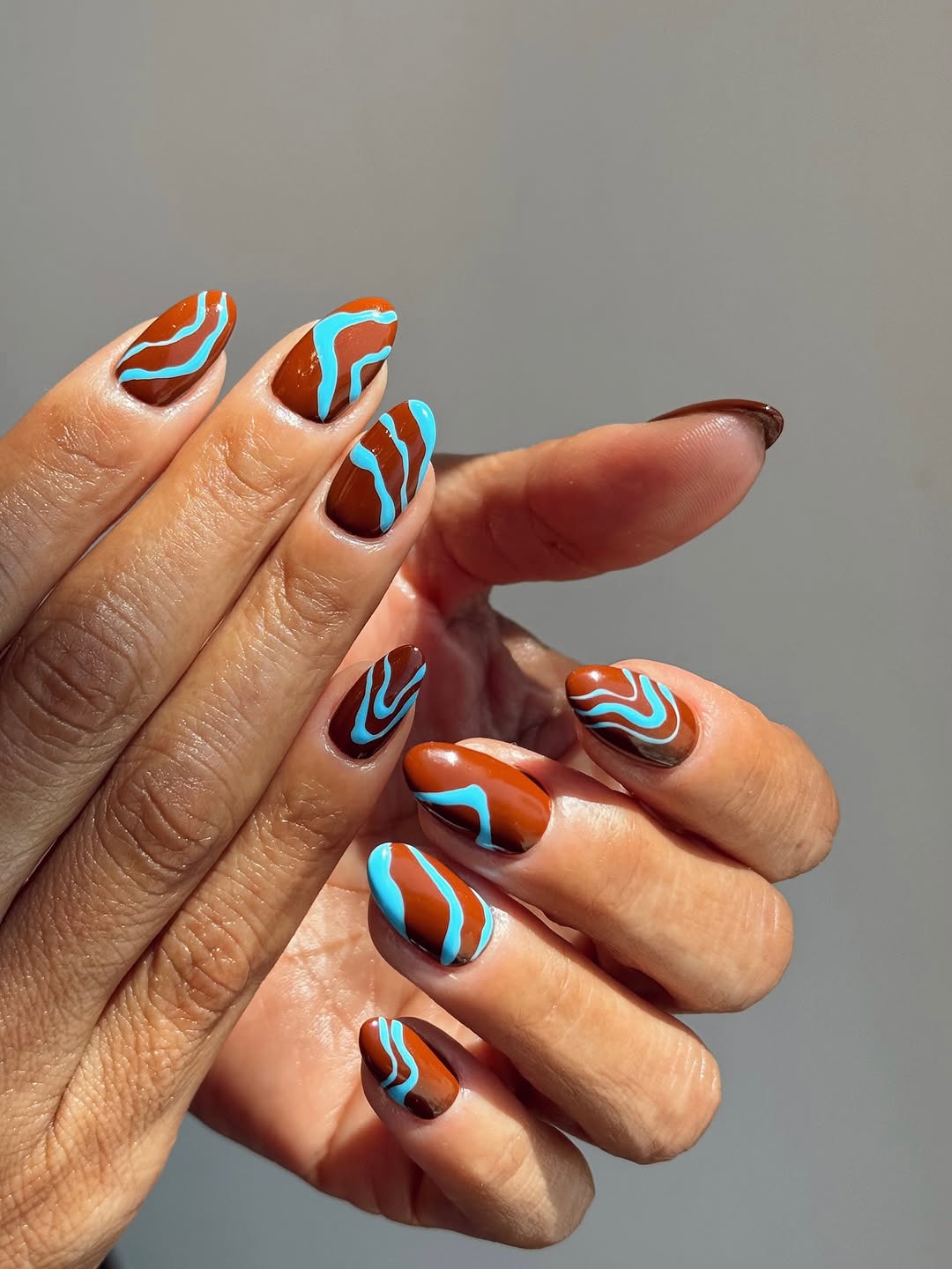Brown Medium Almond Nails With Blue Swirls Brown Medium Almond Nails With Blue Swirls