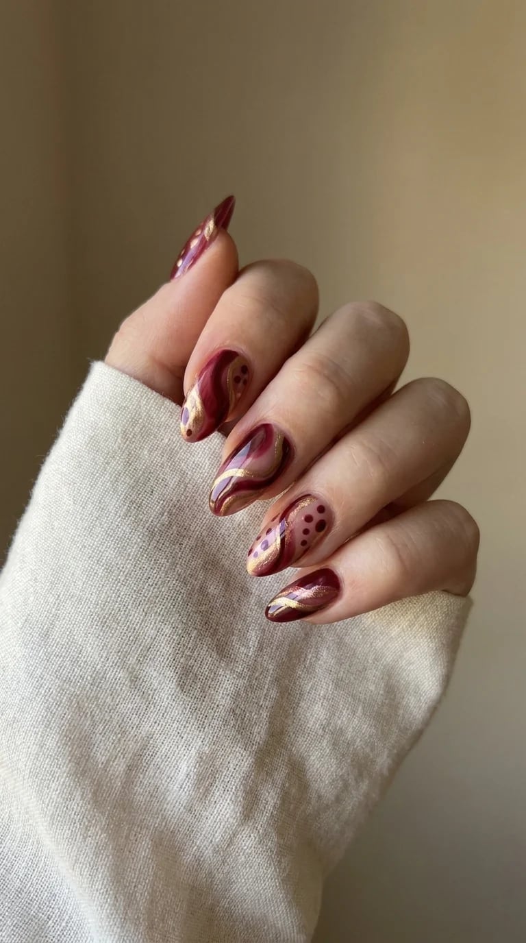 Deep Red Medium Almond Nails With Gold Swirls Deep Red Medium Almond Nails With Gold Swirls