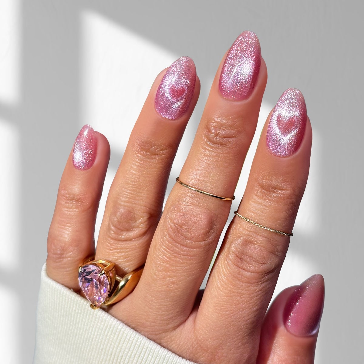 Shimmering Pink Cat-Eye Almond Nails With Hearts Shimmering Pink Cat-Eye Almond Nails With Hearts