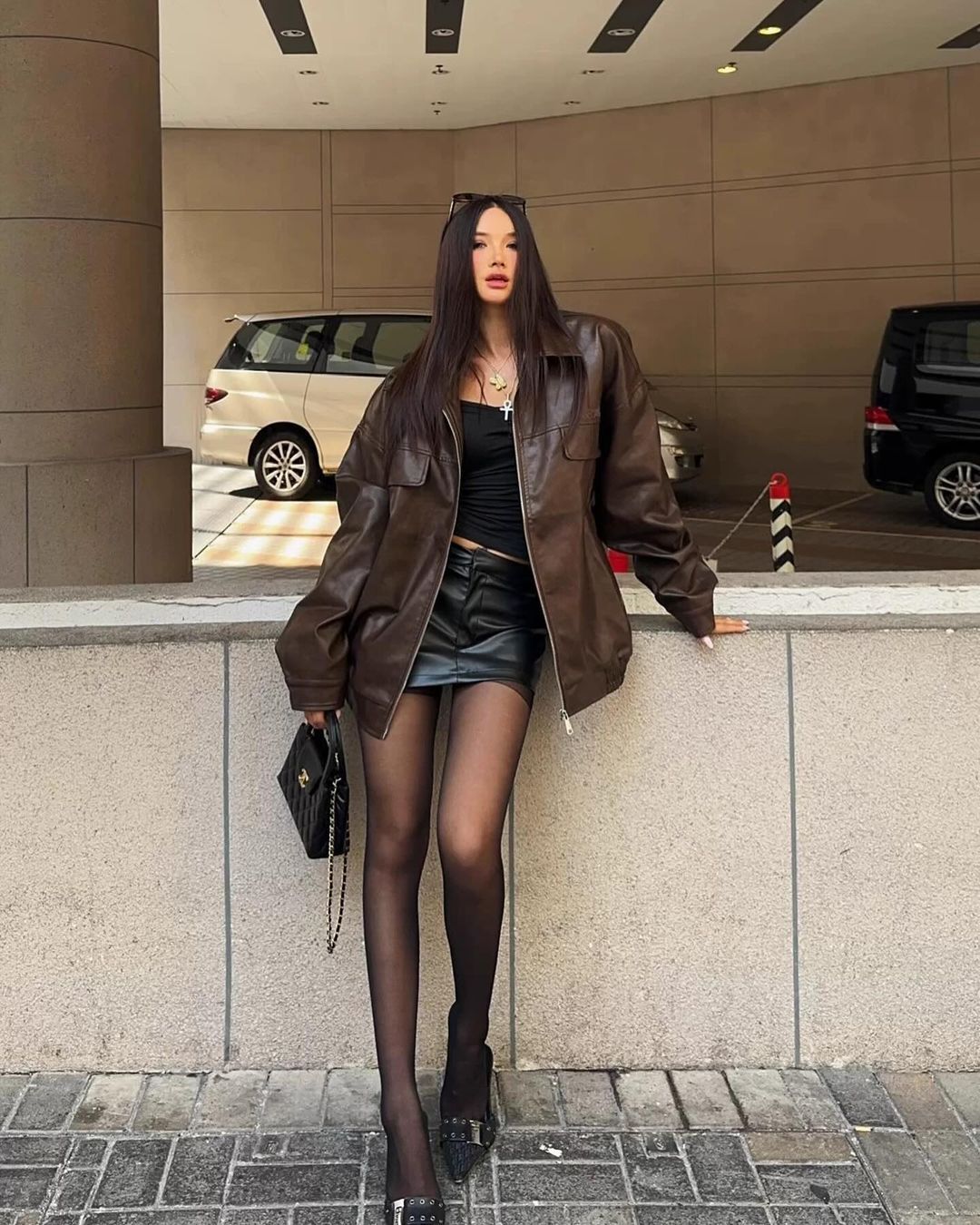 Black Mini Skirt With Sheer Tights And Brown Leather Jacket Black Mini Skirt With Sheer Tights And Brown Leather Jacket — Black Skirt Outfit