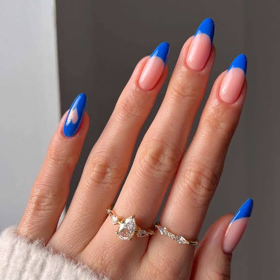 Vibrant Blue French Tips with Pink Heart Accent Medium Almond Nails Vibrant Blue French Tips with Pink Heart Accent Medium Almond Nails — Blue French Tip Nails