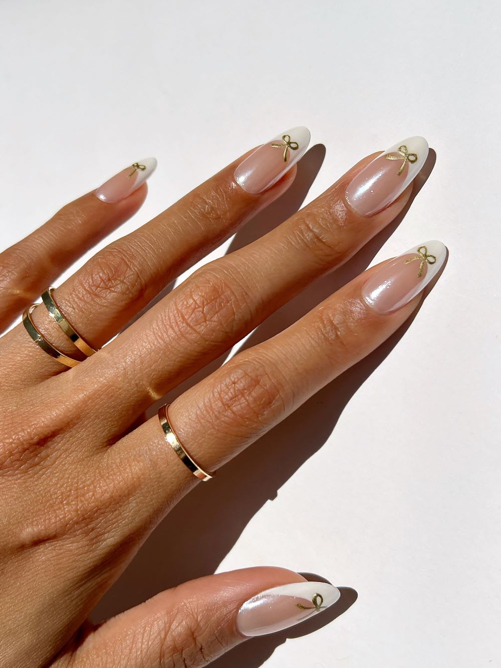 Sheer Nude Pearlescent Long Almond Nails With Gold Bows Sheer Nude Pearlescent Long Almond Nails With Gold Bows — Bow Nails