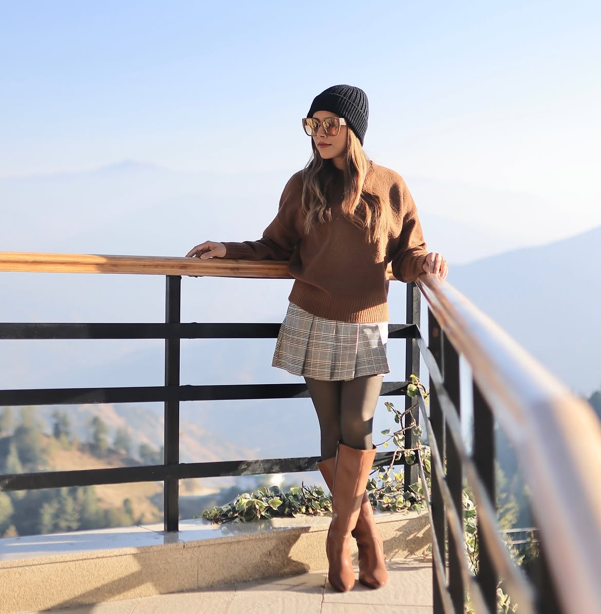 Brown Knit Sweater With Pleated Plaid Skirt And Boots