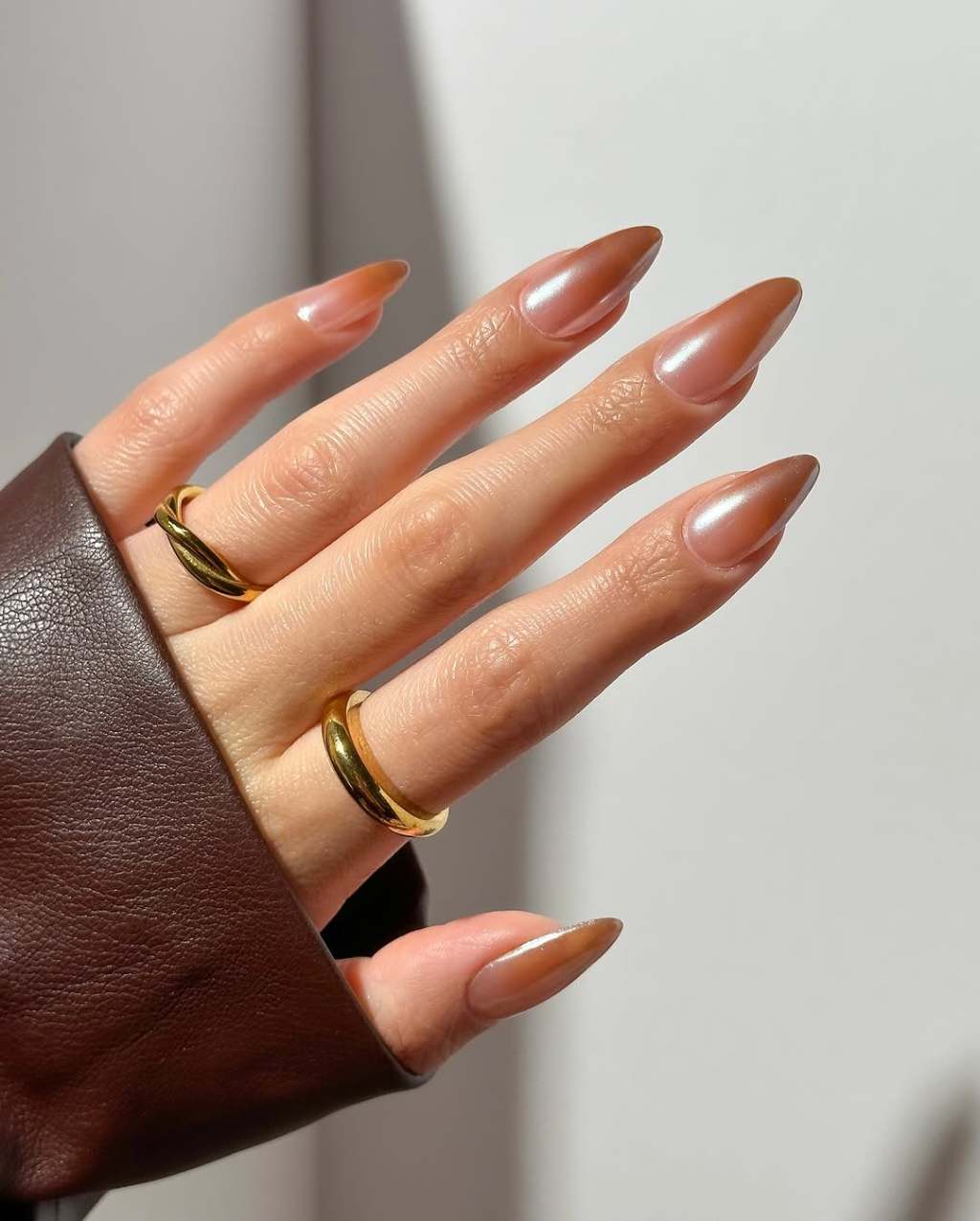 Long Stiletto Shimmer Chrome Brown Nails, Highlighting The Smooth Long Stiletto Shimmer Chrome Brown Nails, Highlighting The Smooth